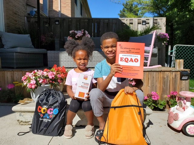 Two children happy and excited to have received their Learn at Home Kits